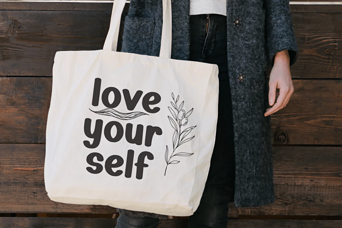 Holiday Christmas rounded handwritten font displayed on a snowy forest background with warm glowing lights and decorative golden frame.